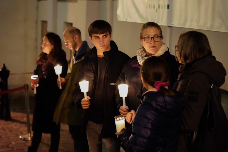 Menschen halten Kerzen vor dem Ort des Anschlags